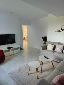 a living room with a couch and a tv at Tu Casina del Norte in Luanco