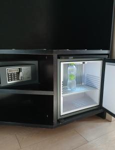 an open microwave with a bottle of water in it at Hotel Aniene in Rome +59 photos
