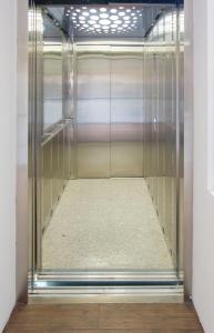 a glass elevator in a room with a floor at Garden Hostel in Skopje +8 photos