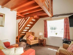 a living room filled with furniture and a large window at Cottage 1 in Keswick