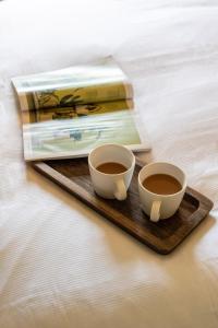 two cups of coffee on a wooden tray with a book at 35 Kirkgate in Thirsk +33 photos
