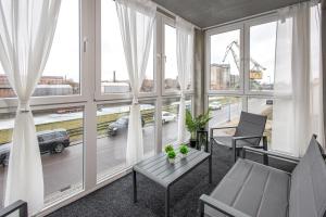 a room with windows with a view of a city at BrockHeus Riverside Aparthotel Magdeburg in Magdeburg