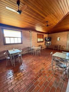 a large room with tables and chairs in it at Hotel Caiçara Matão in Matão