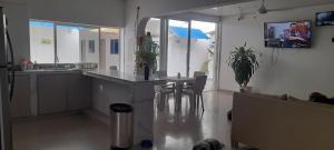 a kitchen and living room with a table and chairs at Hotel Don Toño Tolú in Tolú