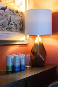 a table with a lamp and glasses on a shelf at 35 Kirkgate in Thirsk