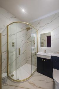 a bathroom with a glass shower and a sink at 35 Kirkgate in Thirsk