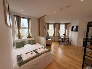 a bedroom with a large bed with two towels on it at The Kove Oceanview in Bournemouth