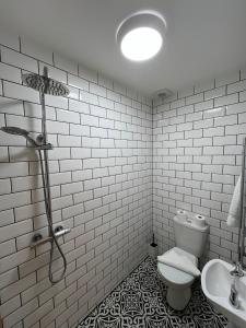 a white bathroom with a toilet and a sink at The Kove Oceanview in Bournemouth