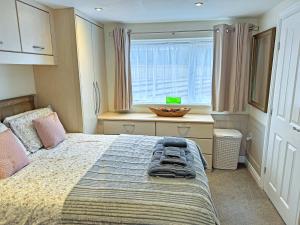 a bedroom with a bed and a window at Little Nauvoo in Bath +6 photos