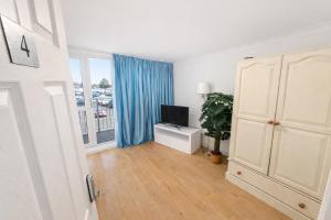 a living room with a television and a window at Spacious Double Room in Shared Flat in Sutton