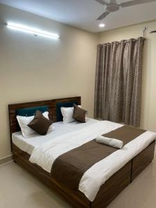 a large bed in a bedroom with a window at Cozy Inn Hotel in Noida +2 photos