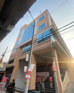 a building with people walking in front of it at Cozy Inn Hotel in Noida