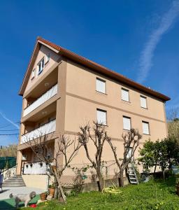 a large apartment building with a tree in front of it at Pensión O Regato in Redondela
