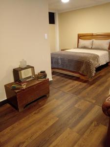 a bedroom with a bed and a tv on a table at Hotel Gavilu in Ambato