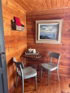 a dining room with two chairs and a table at La Demeure des Elfes in Albinen