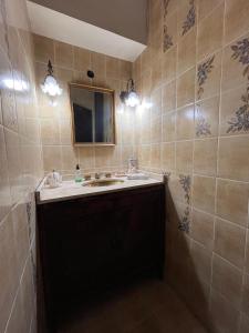 a bathroom with a sink and a mirror at La casa del recho in Santo Tomé +3 photos