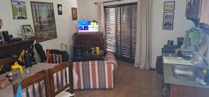 a living room with a table and a sink and a television at La casa del recho in Santo Tomé