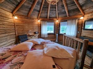 a bedroom with three beds in a wooden cabin at Lapuanjoen Rantakeidas in Voltti +149 photos