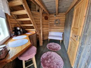 a room with a table and stools in a cabin at Lapuanjoen Rantakeidas in Voltti