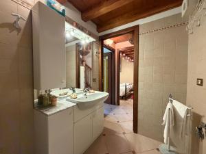 a bathroom with a sink and a mirror at DOMA LUXURY HOMe in Desenzano del Garda
