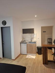 a kitchen with a sink and a counter top at Secret Night in Audincourt