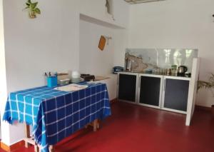 a kitchen with a blue table in a room at Thisu villa in Weligama