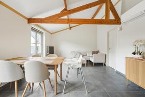a dining room with a table and chairs at Duinhuis 20 P in Oostduinkerke +10 photos