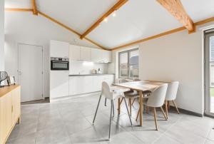 a kitchen and dining room with a table and chairs at Duinhuis 20 P in Oostduinkerke