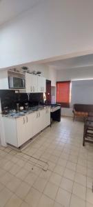 a room with a kitchen with a stove top oven at Apto cerca a Paseo Colon in Puerto La Cruz