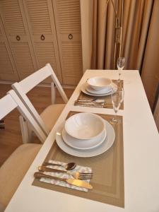 a table with two plates and a glass of wine at Osterley Room in Isleworth