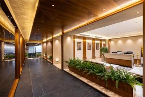 an empty lobby with a piano and plants at AIRA Boutique Hotel in Bangalore