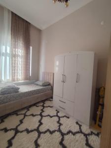 a bedroom with a bed and a white cabinet at Yörük konaklama in Burdur