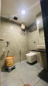 a bathroom with a toilet and a sink at Hotel Leaf inn in Ahmedabad