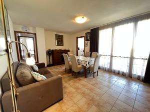 a living room with a couch and a table with chairs at Campo Porta Nuova in Grado +1 photo