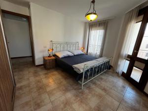 a bedroom with a bed and two windows at Campo Porta Nuova in Grado