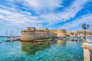 a group of boats in the water next to a harbor at Suite Acquamarine by Symphonya Luxury Holiday Rentals in Gallipoli