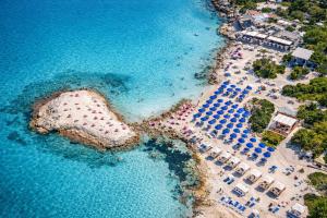 an aerial view of a beach with umbrellas and the water at Suite Acquamarine by Symphonya Luxury Holiday Rentals in Gallipoli +8 photos
