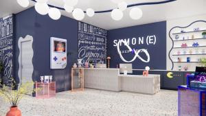 a store with a blue wall with drawings on it at Symone - Poitiers in Poitiers