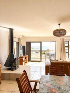 a living room with a couch and a fireplace at Fluisterbaai in Britannia Bay