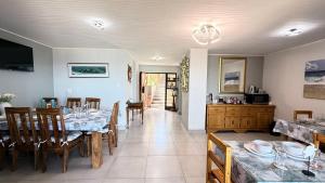 a kitchen and dining room with a table and chairs at Lilies & Leopards B&B in Mossel Bay