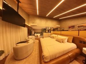 a bedroom with a large bed and a couch at Fazzenda Park Resort in Gaspar