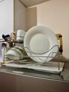a rack with plates and bowls on top of a dishwasher at Jo Condotels at Persimmon Tower3 in Cebu City