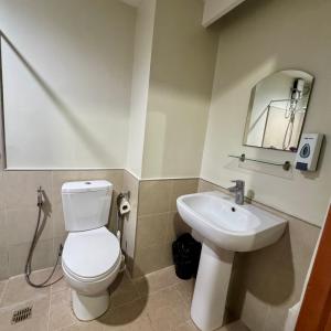 a bathroom with a white toilet and a sink at Jo Condotels at Persimmon Tower3 in Cebu City +30 photos