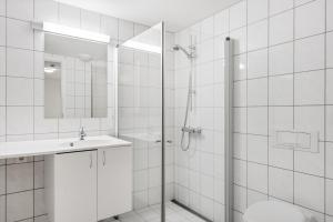 a bathroom with a shower and a toilet and a sink at Stølstunet Leilighet 617 in Beitostøl +11 photos