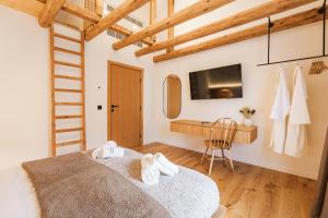 a bedroom with a bed and a desk and a television at Chalet Charm - Private Mountain Retreat with Sauna, Jacuzzi & Kids Playroom in Bansko