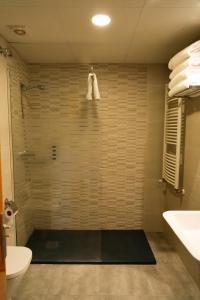 a bathroom with a shower with a toilet and a sink at Apartamentos SNÖ Edelweiss in Cerler +19 photos
