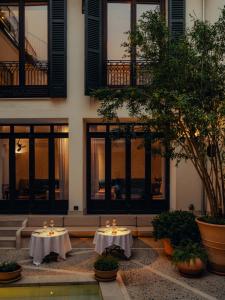 two tables in a courtyard in front of a building at Portella Palma in Palma de Mallorca