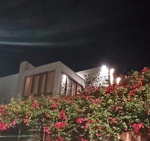a building with a bunch of flowers in front of it at Kos View City , Luxury Old Town in Kos