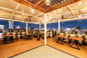 a room with tables and chairs and a view of the city at AIRA Boutique Hotel in Bangalore