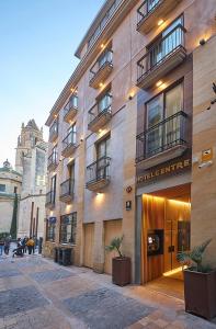 a building on a street with people walking in front of it at Hotel Centre Reus in Reus